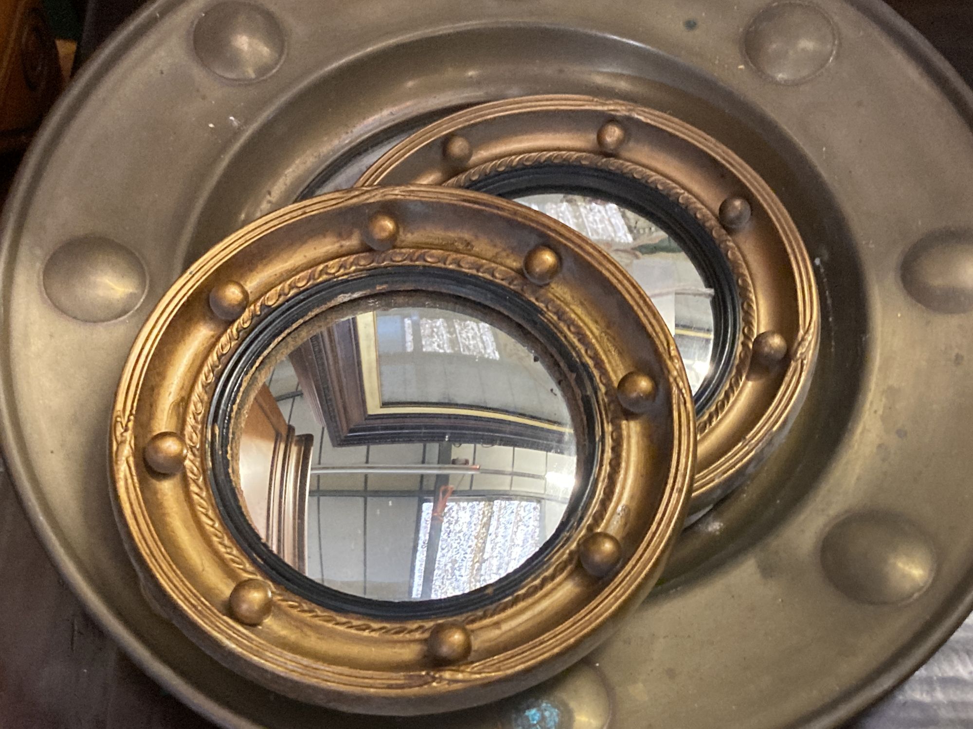 Five gilt and brass framed circular convex wall mirrors, largest 50cm diameter